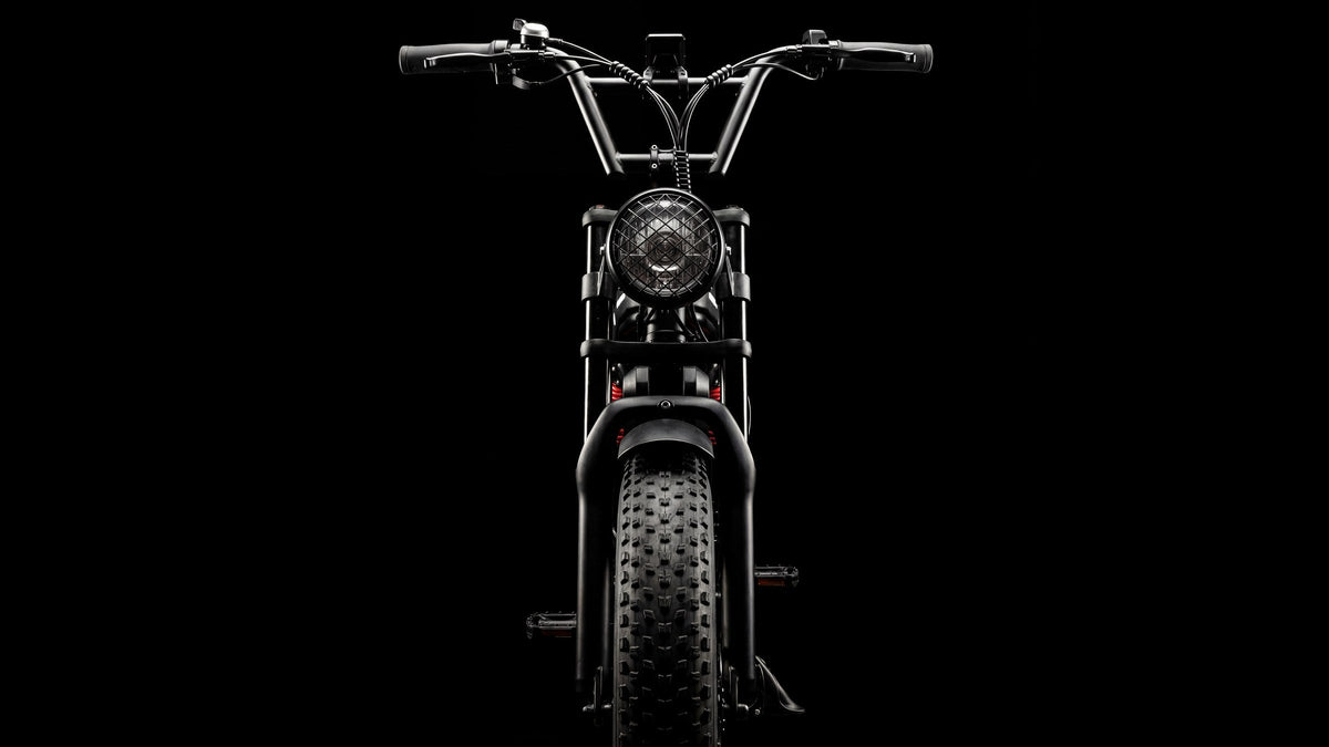 SWAGTRON UrbanCruise e-bike head-on with caged headlight and fat front tire