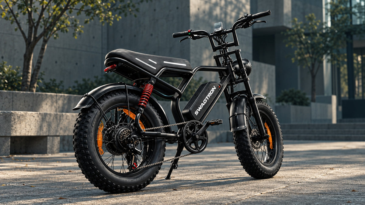 SWAGTRON e-bike, rear three-quarter view, parked on stone paving outside a concrete building