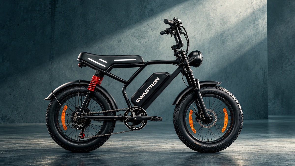 SWAGTRON UrbanCruise e-bike in side profile on a concrete floor, lit by a shaft of light against a blue-gray concrete wall