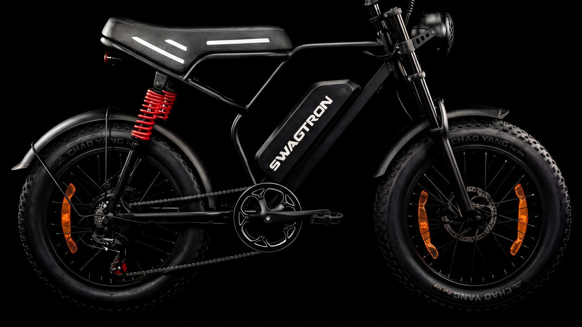 SWAGTRON UrbanCruise e-bike side profile with red coil-over rear shock and 20-inch fat tires
