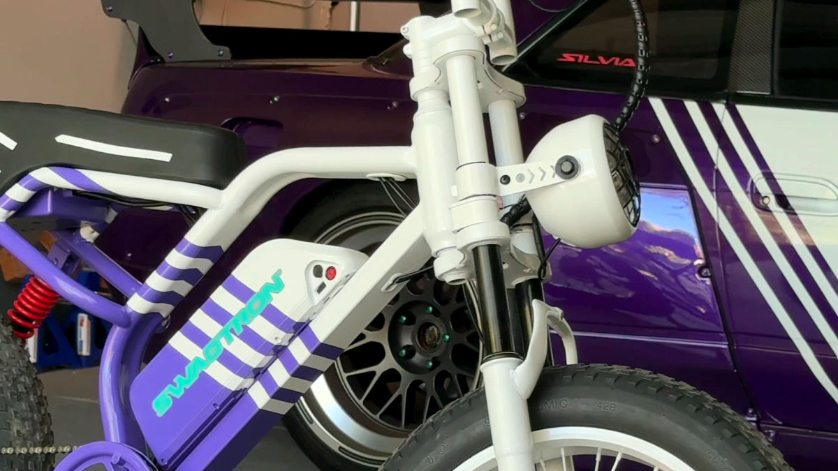 Austin Mollno's custom SWAGTRON UrbanCruise e-bike in front of his Nissan S13.